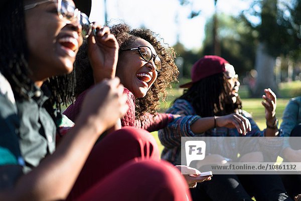 Group of female friends relaxing in park  laughing