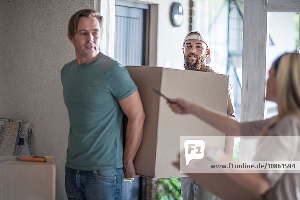 Moving house: two men carrying cardboard box