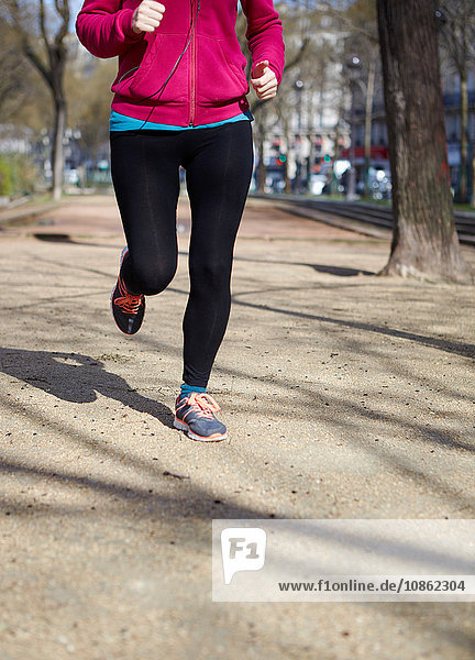 Low section of woman jogging