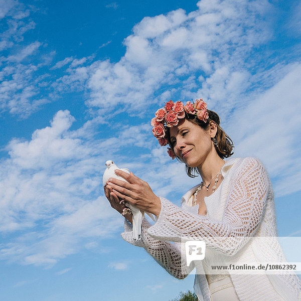 Woman holding white dove