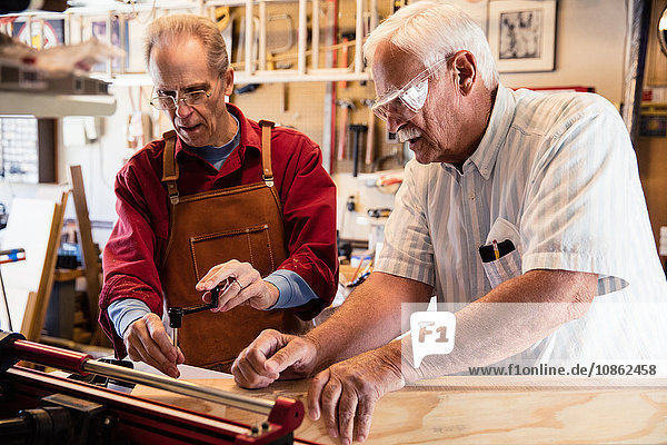 Senior men working with carpentry equipment workshop