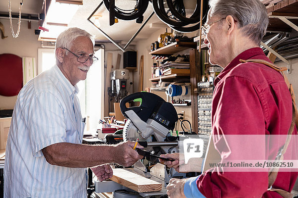 Senior men handing angle rule in carpentry workshop