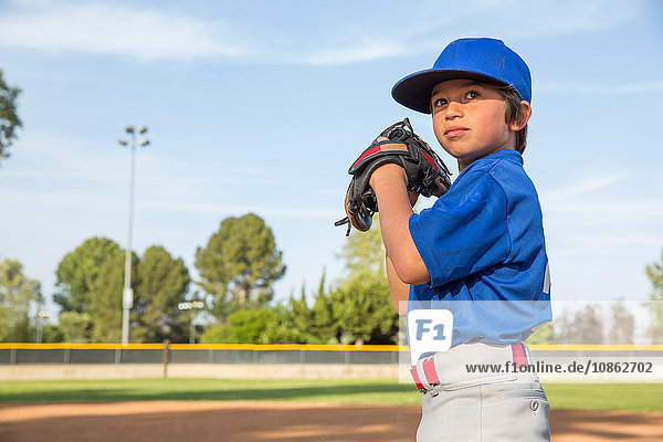 Boy preparing to throw at practise on baseball field
