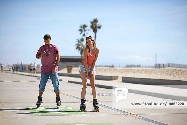 Couple rollerblading outdoors