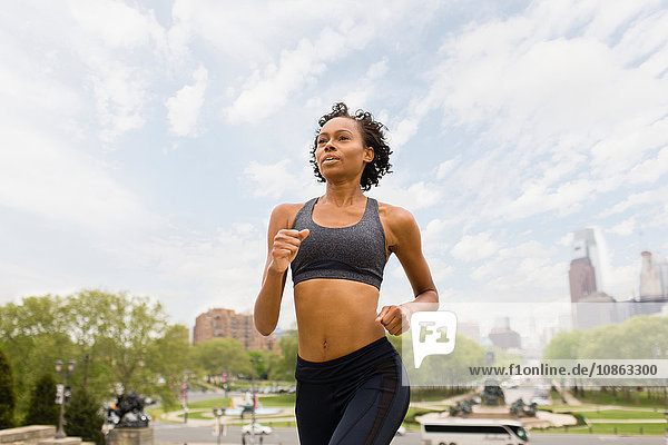 Woman wearing sports clothing jogging in city
