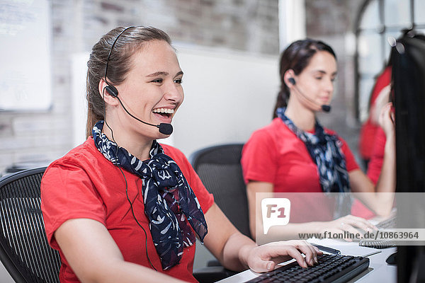 Row of female telephonists working in call centre