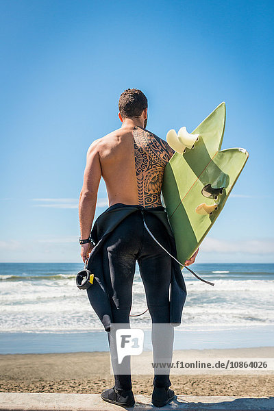 Surfer carrying surfboard  San Francisco  California  USA