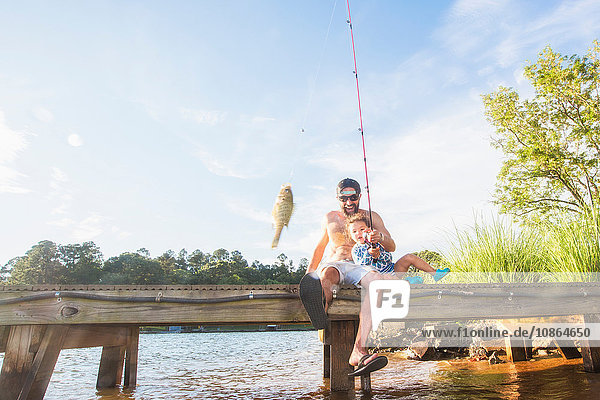 Father and daughter fishing at Lake Jackson  Atlanta  Georgia  USA