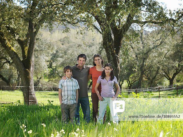 Family portrait in field with trees