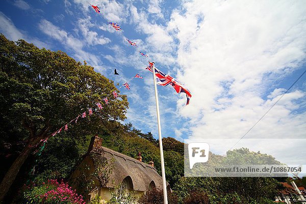 British flag on flagpole in village