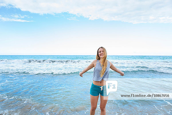 Portrait of young woman with arms open in sea  Dominican Republic  The Caribbean