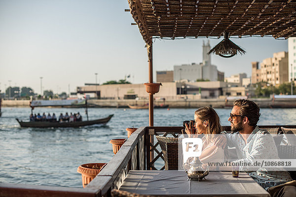 Romantic couple photographing from Dubai marina cafe  United Arab Emirates