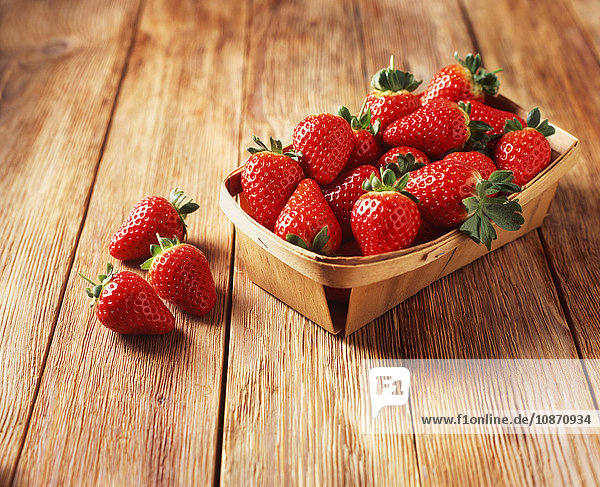 Punnet von Erdbeeren auf Holztisch