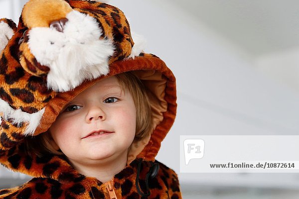 Girl dressed up in animal costume looking away smiling