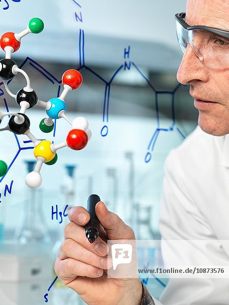 Wissenschaftlerin mit Kugel und Stock Molekularmodell schreibt Formel eines neuen Medikaments auf Glas