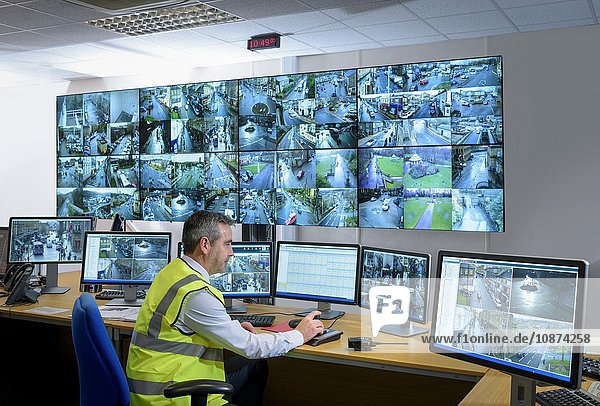Security guard in security control room with video wall