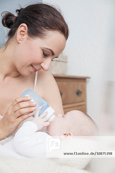 Mother feeding baby with bottle