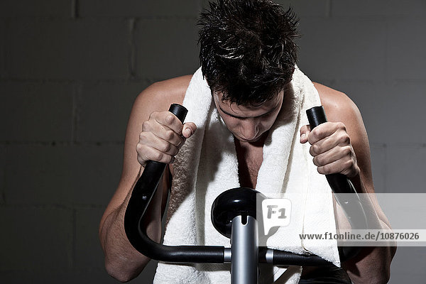 Man using exercise machine looking down