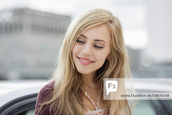 Beautiful long haired blond young woman in city