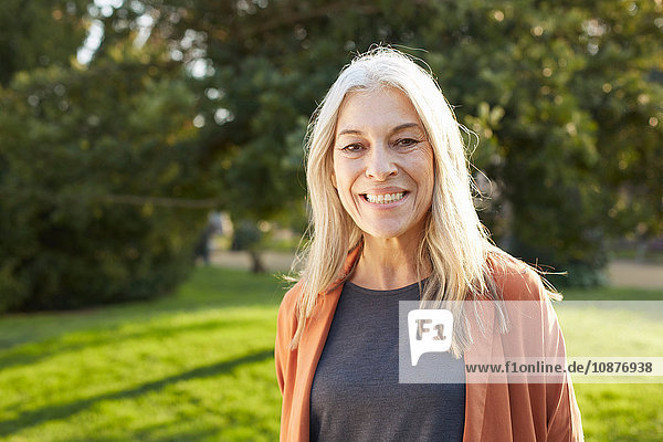 Portrait of grey haired senior woman looking at camera smiling