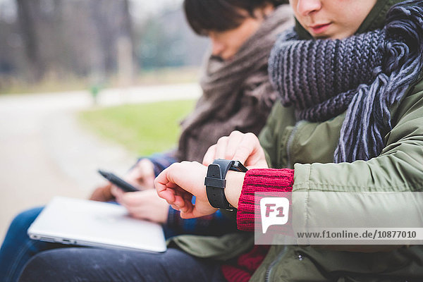 Young woman using smartwatch  outdoors