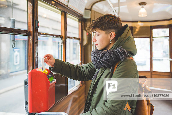 Young woman taking ticket on cable car