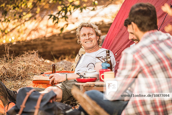 Men camping in forest drinking beer and coffee Deer Park Cape Town South Africa