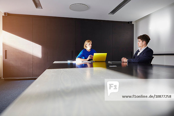 Colleagues in conference room at conference table having meeting