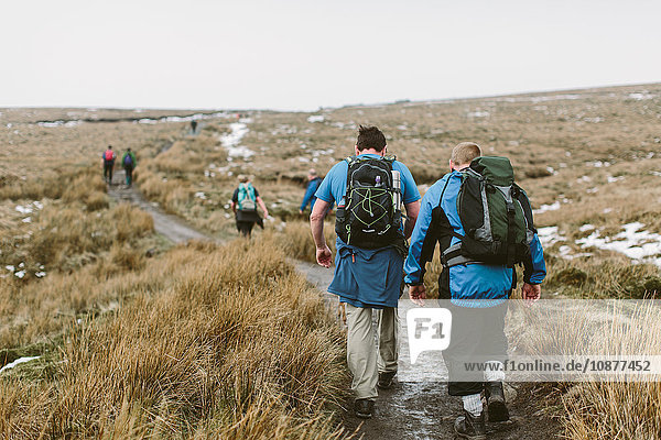 Hikers crossing moor Yorkshire Dales National Park England