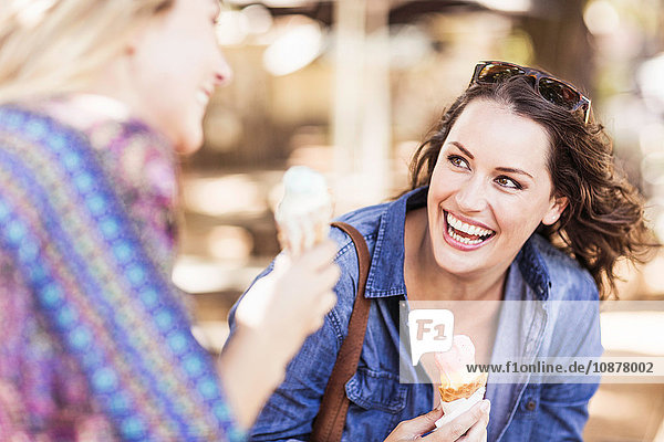 Frau hält Eistüte in der Hand und sieht ihren Freund lächelnd an