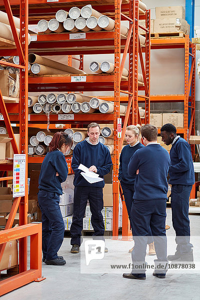 Manager training factory work team in factory warehouse