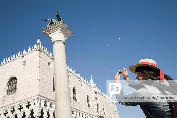 Young woman photographing St Marks Basilica  Venice  Italy