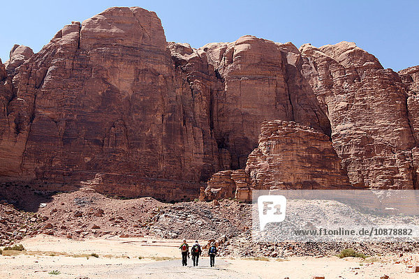 Three hikers hiking in Wadi Rum  Jordan