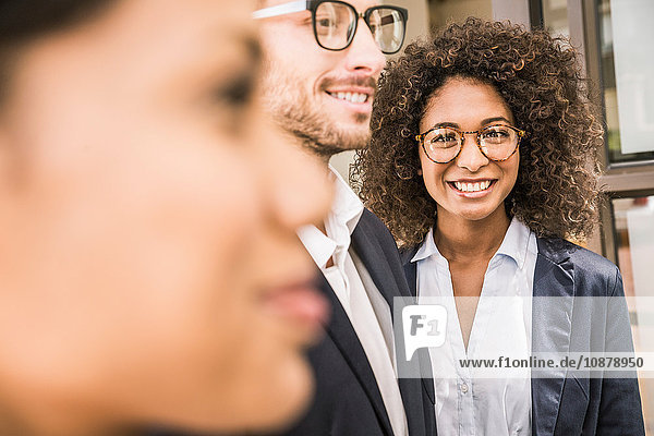Close up of businesswomen and businessman outside office
