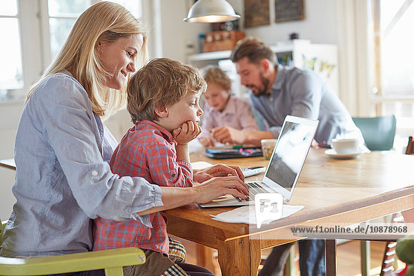 Parents and sons working in home office