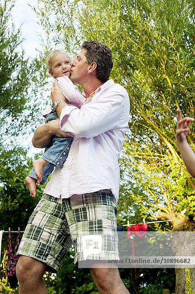 Sweden Skane Father holding and kissing daughter (2-3)