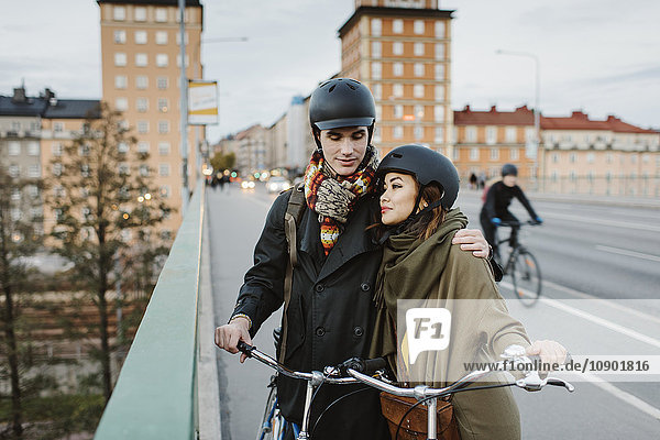 Schweden Uppland Stockholm Vasatan Sankt Eriksgatan Junges Paar mit Fahrrädern auf der Straße