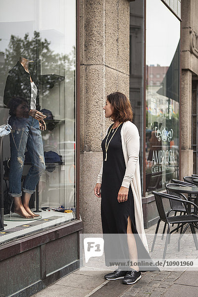 Sweden Skane Malmo Mature woman looking at display window