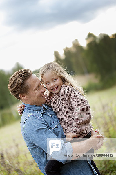 Finland  Uusimaa  Raasepori  Karjaa  Father holding in arms his daughter (6-7)
