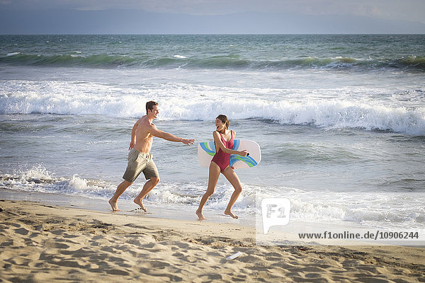 Young couple having fun on the beach