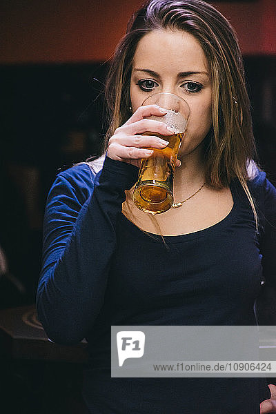 Woman drinking a glass of beer
