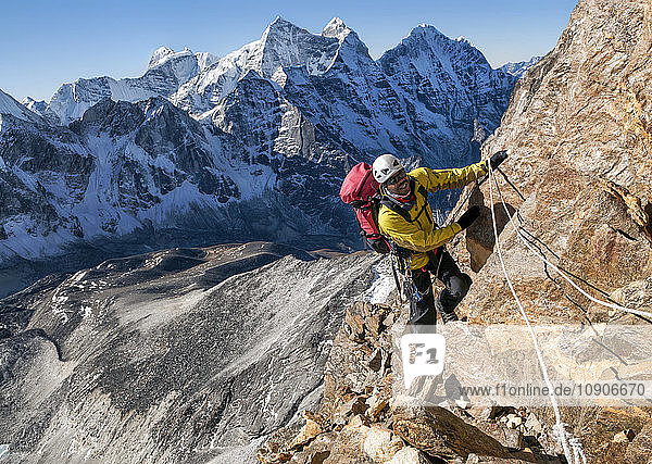 Nepal  Himalaya  Solo Khumbu  Ama Dablam South West Ridge  mountaineer climbing up rocks