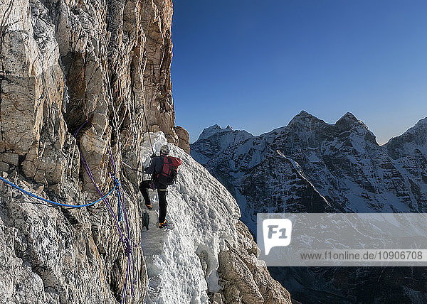 Nepal  Himalaya  Solo Khumbu  Ama Dablam South West Ridge  mountaineer climbing up rocks