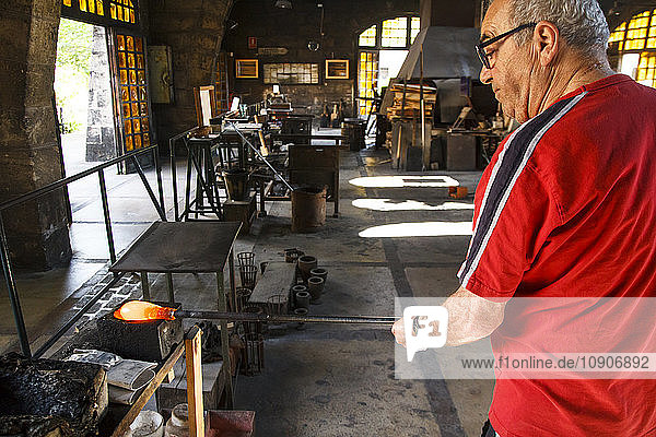 Man working with molten glass in a Factory in Mallorca