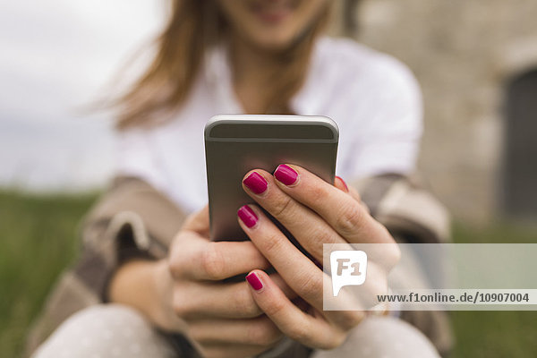 Hands of woman holding smartphone