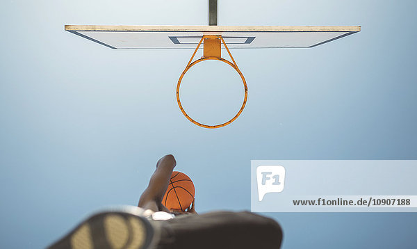Junger Mann zielt auf Basketballkorb