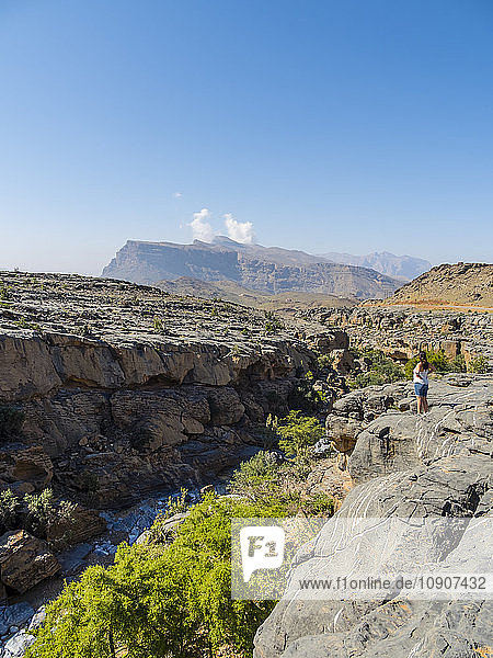 Oman  Jebel Shams  woman standing on viewing point