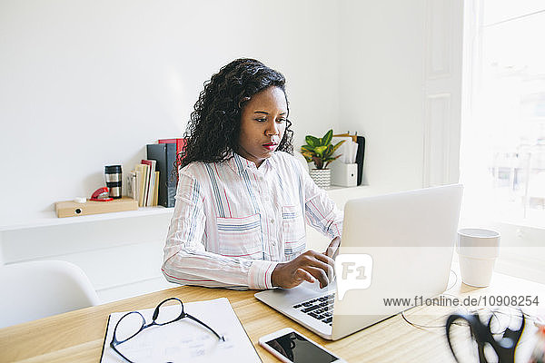 Young woman working in office  using laptop
