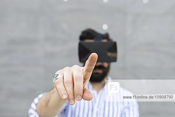 Forefinger of man playing with Virtual Reality Glasses typing in the air