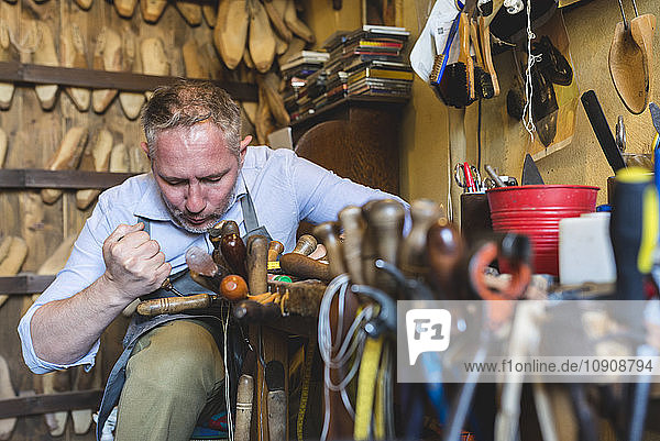 Cobbler making shoes in his workshop